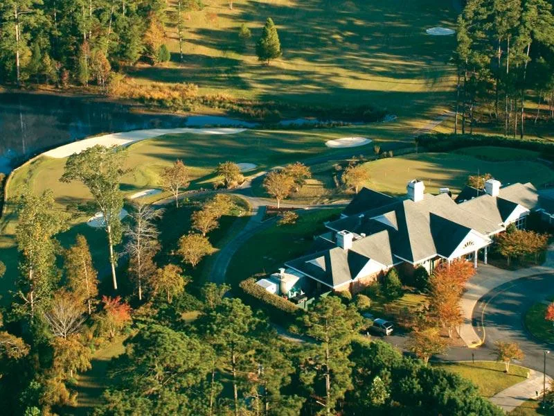 Actual photograph of the Tara clubhouse above the ninth green with autumn color around it