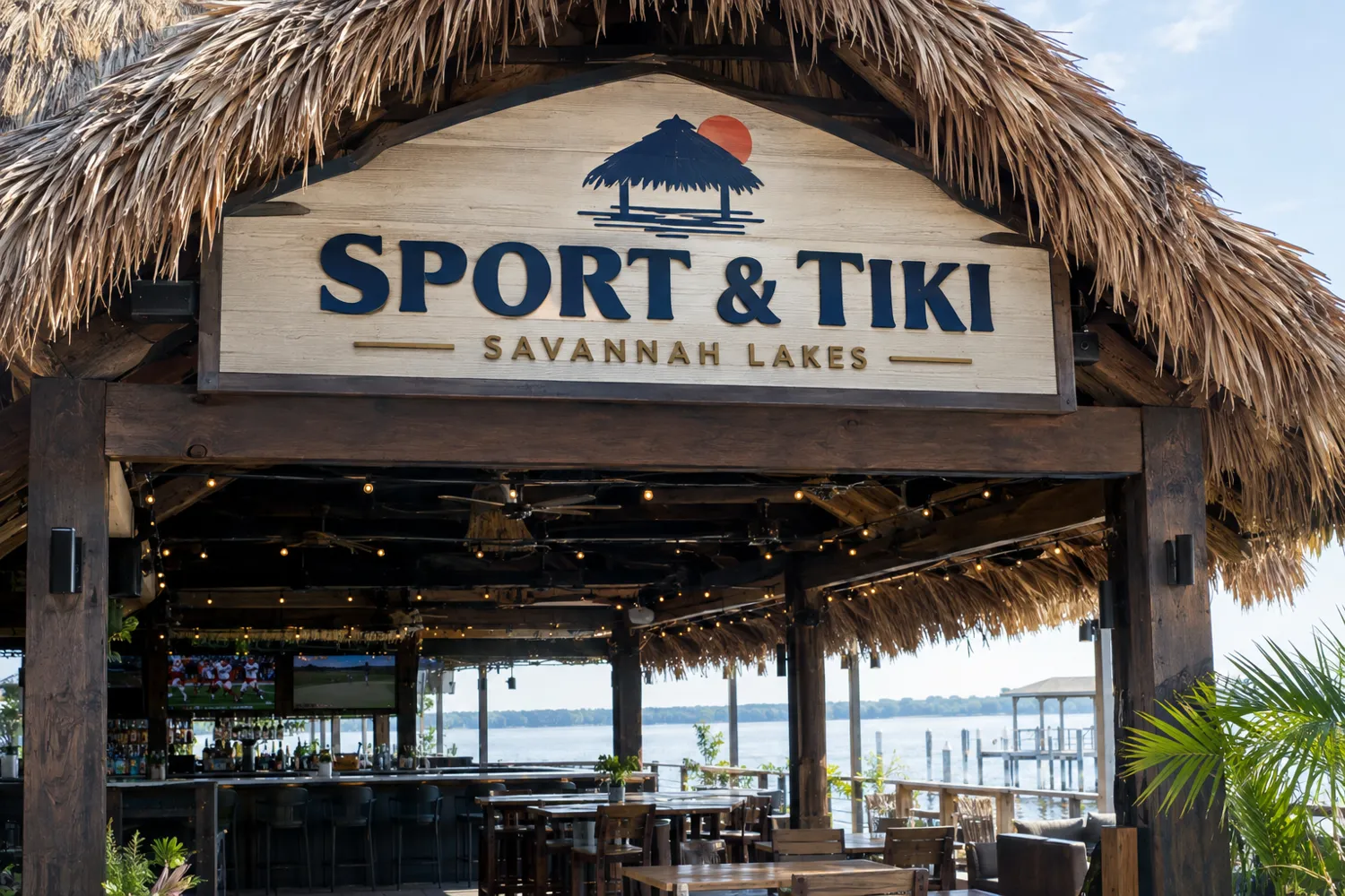 Concept rendering of the Sport and Tiki entrance with a carved sign under a thatched roof and the lake beyond the bar