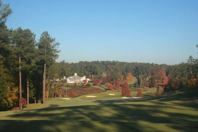 Photograph looking down Tara's ninth hole toward the clubhouse with autumn color in the trees